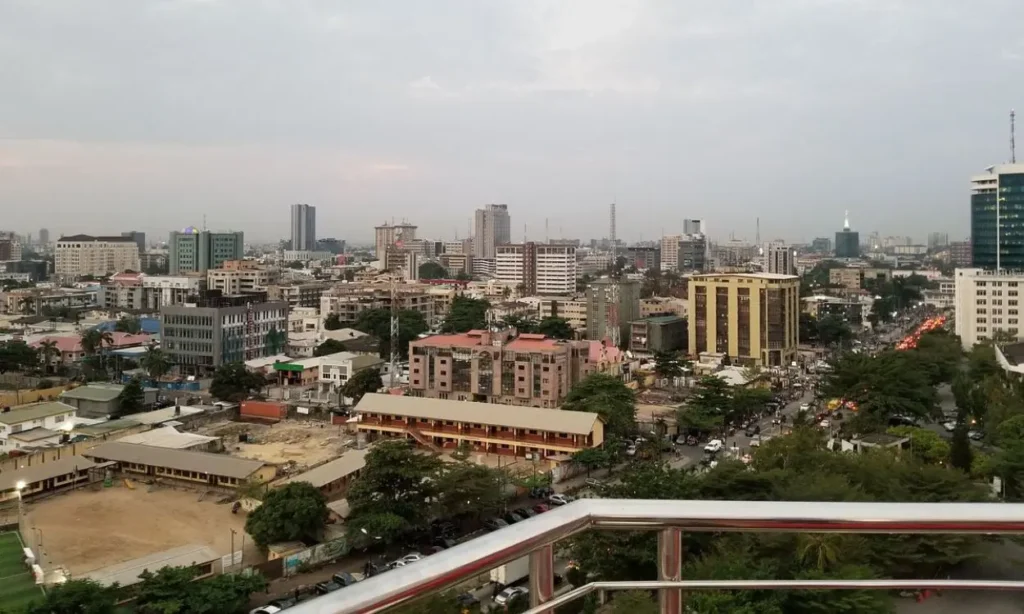 An aerial view of Lagos showing a mix of high-rise buildings, roads, and urban structures.