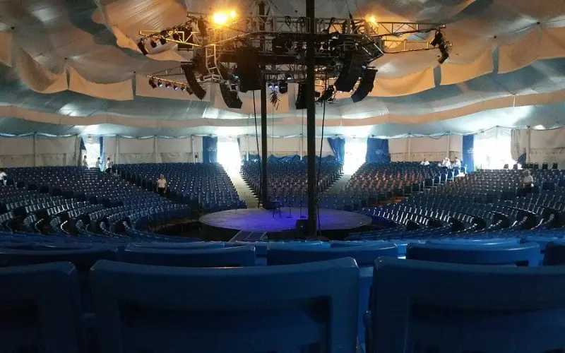 Circular stage and seating inside The Melody Tent.