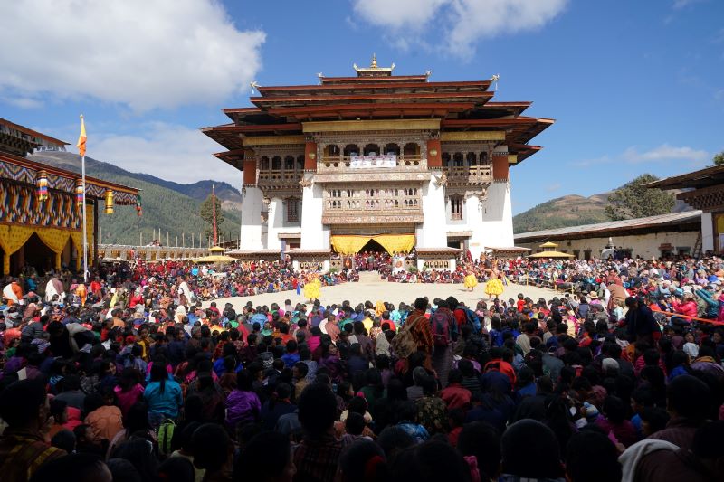 Visitors meditating amidst the beautiful Gangtey Monastery backdrop