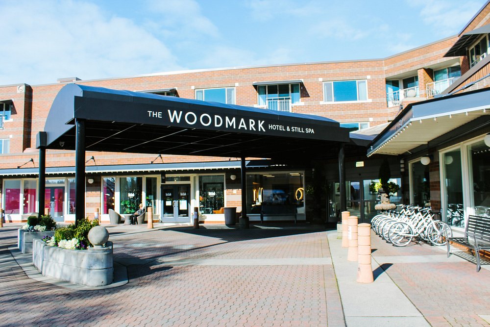 Entrance of The Woodmark Hotel and Still Spa with canopy and bicycles outside.