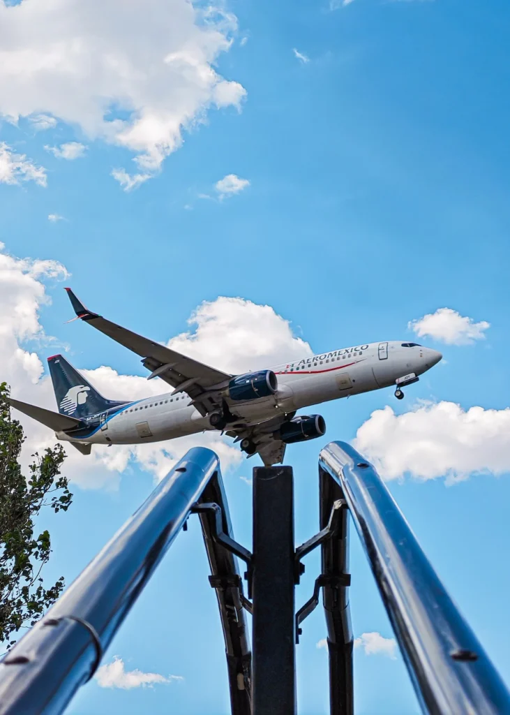 Aeromexico Boeing 737 airplane landing on a sunny day with landing gear down