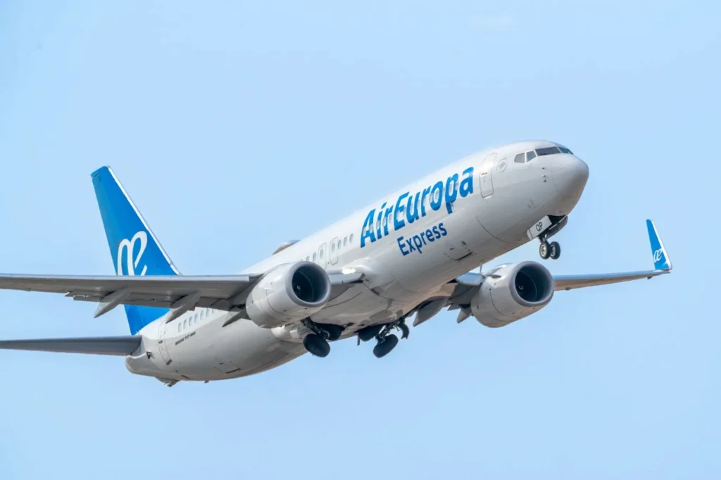 An Air Europa Express Boeing 737 MAX 8 passenger airplane climbing into a clear blue sky