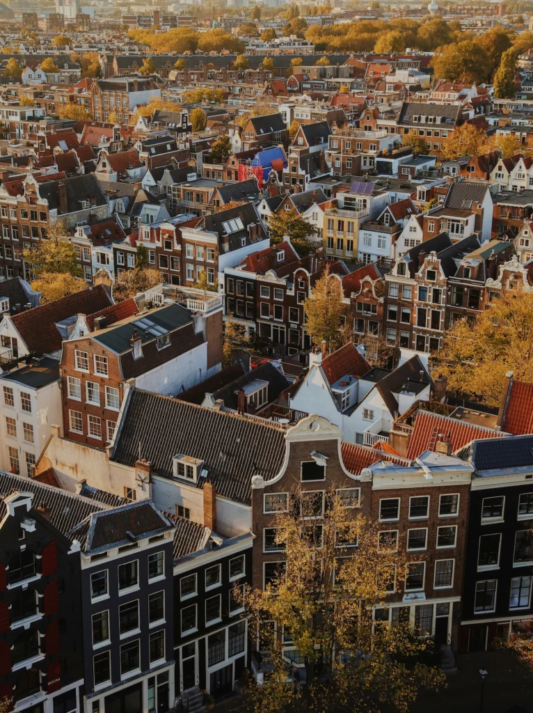 High angle view of historic gabled canal houses and rooftops in Amsterdam