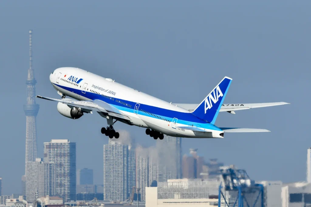 ANA Boeing 777-300ER aircraft climbing past Tokyo Skytree after taking off from Haneda Airport