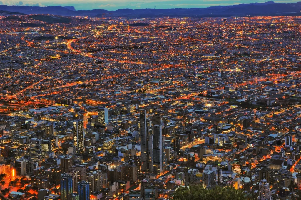 High-angle aerial view of the illuminated Bogota city skyline at night from Monserrate