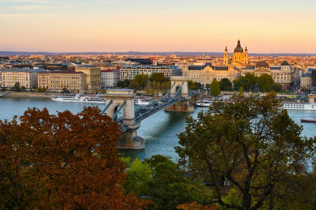 Szechenyi Chain Bridge crossing the Danube River in Budapest with St. Stephen's Basilica behind