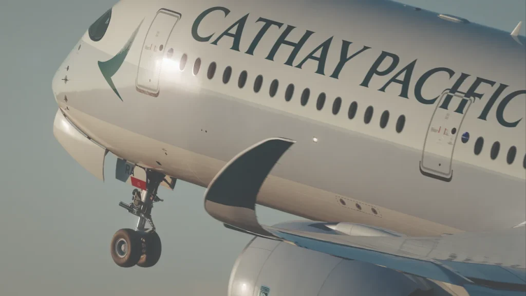 A close-up view of the nose and fuselage of a Cathay Pacific Airbus A350 passenger airplane