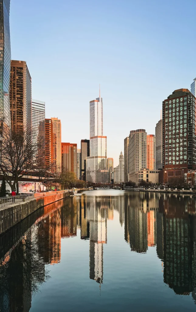 Skyscrapers including the Trump International Hotel and Tower reflecting perfectly in the calm Chicago River under a clear sky