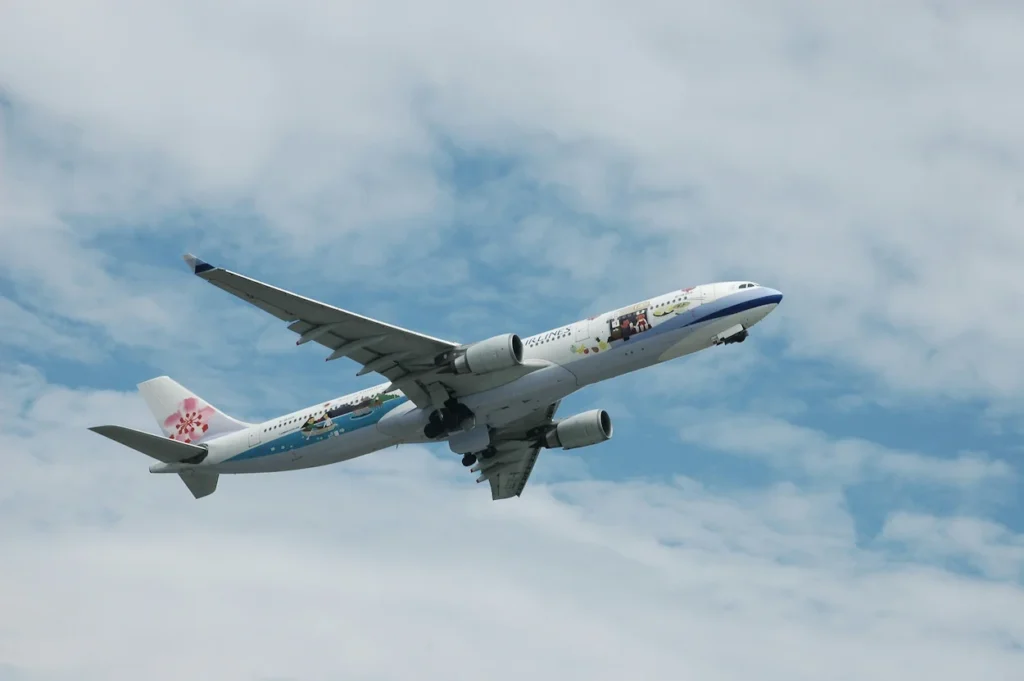 A China Airlines Airbus A330 with custom livery ascending into a cloudy sky
