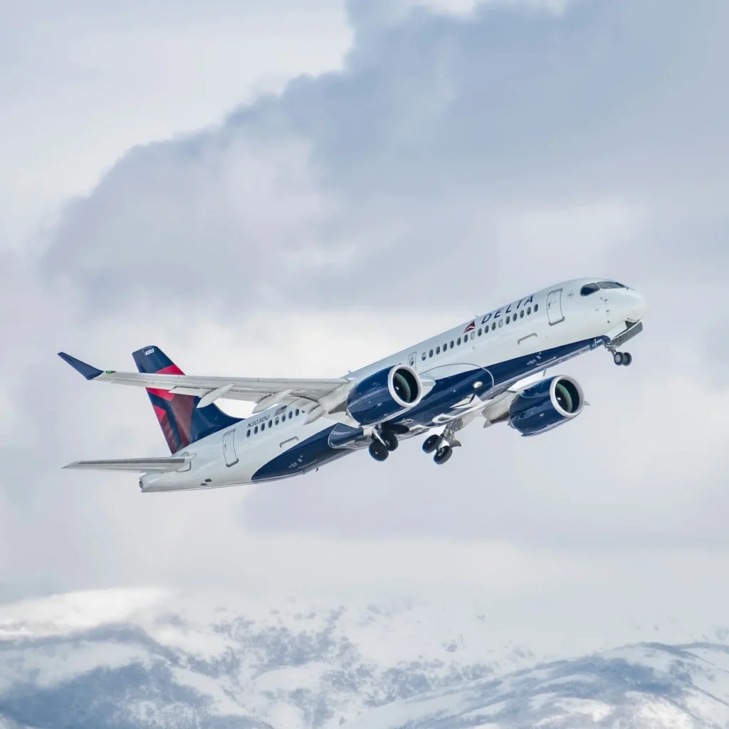 Delta Air Lines Airbus A220 passenger airplane climbing steeply during takeoff