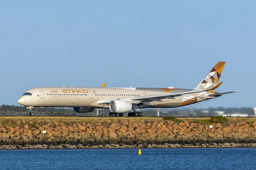 Etihad Airways Airbus A350-1000 passenger plane taxiing on a coastal runway