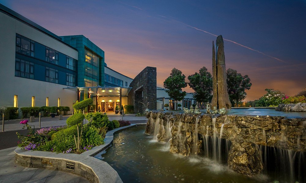 Fota Island Resort exterior at sunset with waterfall feature and landscaped entrance.