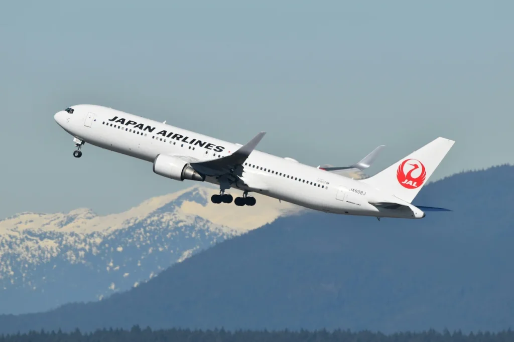 Japan Airlines Boeing 767 passenger aircraft climbing steeply into the sky