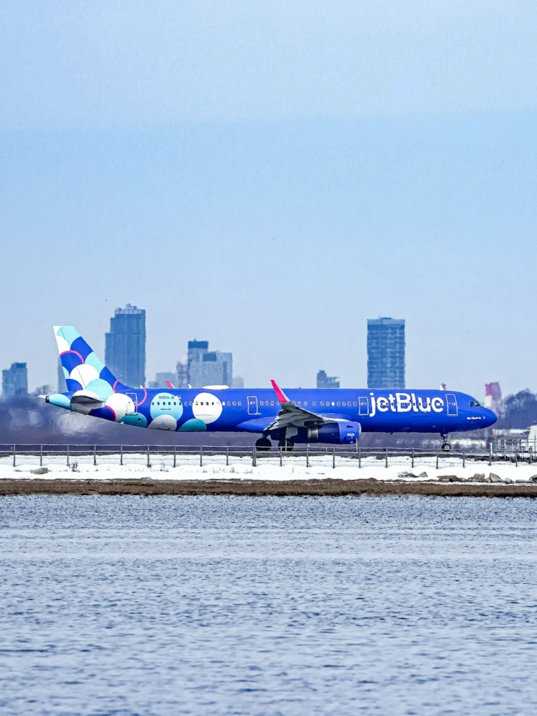 JetBlue Airbus A321neo aircraft featuring the vibrant balloons livery on a snowy runway