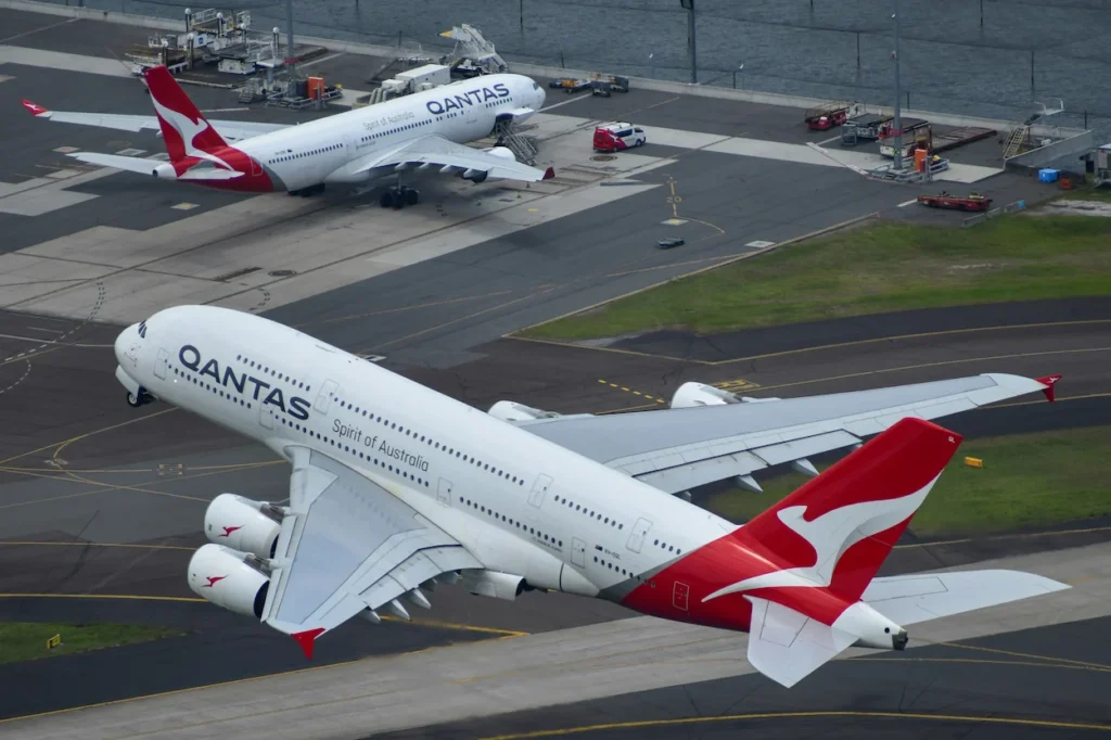 Aerial view of a Qantas Airbus A380 double-decker passenger airplane taking off