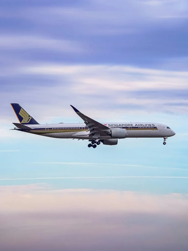 Singapore Airlines Airbus A350-900 aircraft on final landing approach with gear down against a layered cloud sky