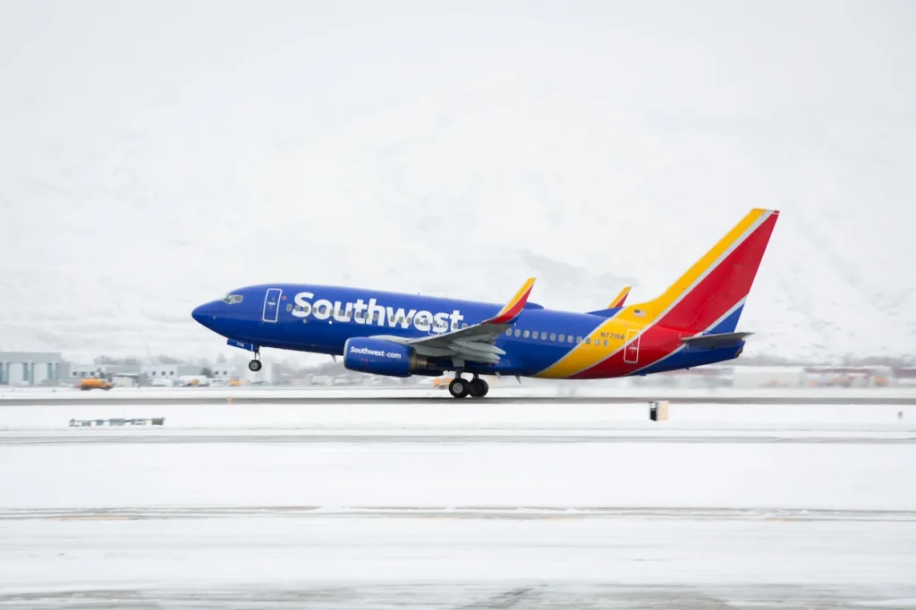 Southwest Airlines Boeing 737 airplane taking off from a snow-covered airport runway