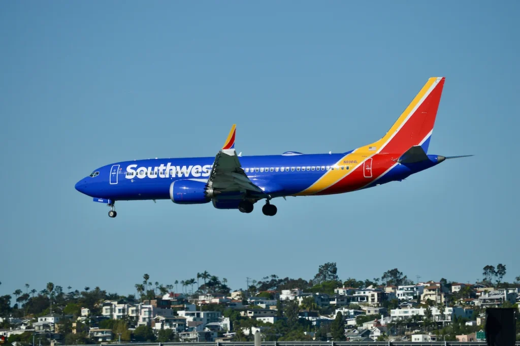Southwest Airlines Boeing 737 commercial airplane descending for landing against a clear blue sky