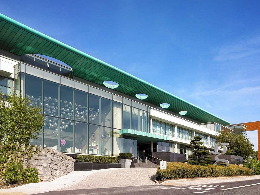 Exterior view of The G Hotel & Spa with modern glass facade and green roof.