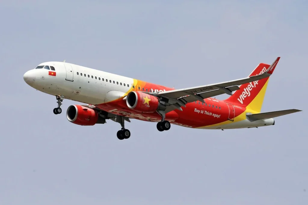 VietJet Air Airbus A320 passenger airplane flying with its landing gear down
