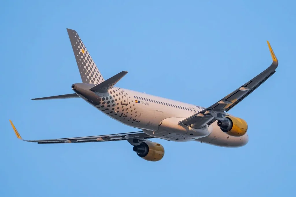 A low-angle rear view of a Vueling Airlines Airbus A320 passenger airplane