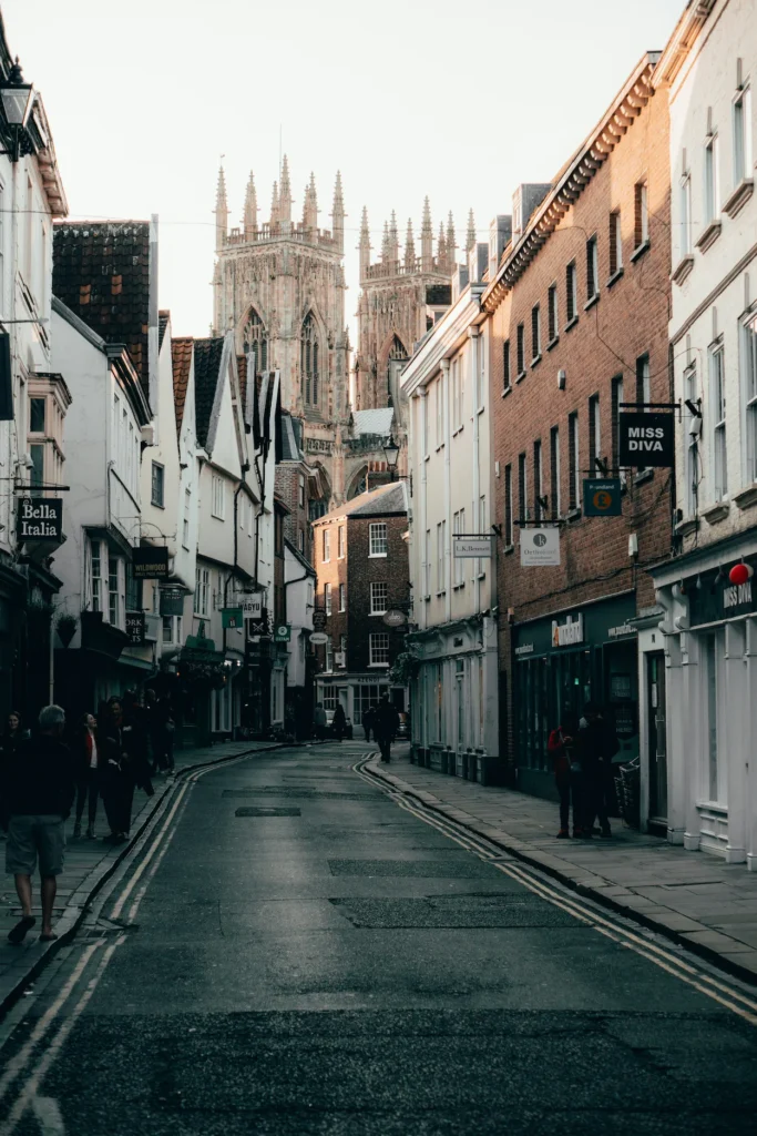 York Minster rising above the storefronts of Low Petergate street