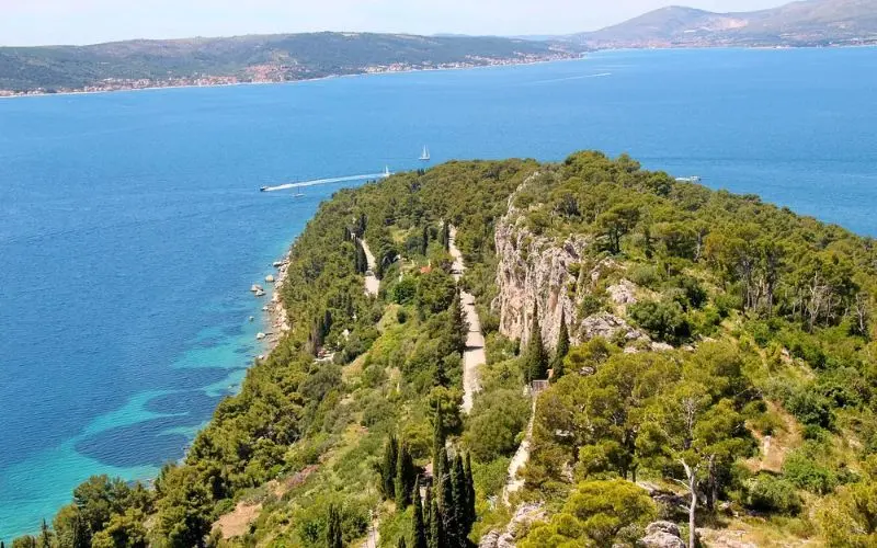 Aerial view of Marjan Hill covered in trees and surrounded by the Adriatic Sea.