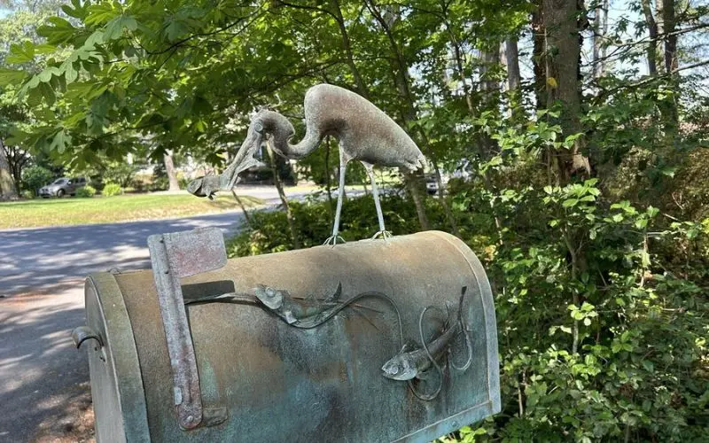 Artistic mailbox with bird and fish sculptures at Rehoboth Art League.