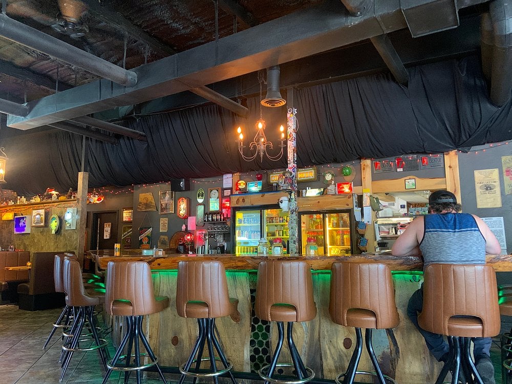 Interior of Burrowing Owl with retro bar stools, eclectic decor, and a relaxed pub vibe.