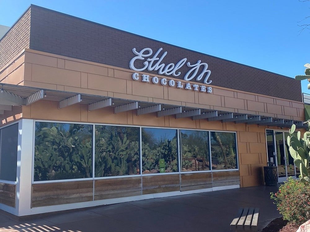 Ethel M Chocolates factory building with large windows and cactus reflections.