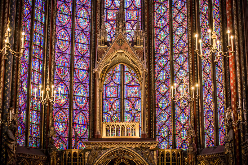 Sainte-Chapelle in the heart of the city, an architectural masterpiece, dazzles with vibrant stained-glass windows within the medieval Palais de la Cité.