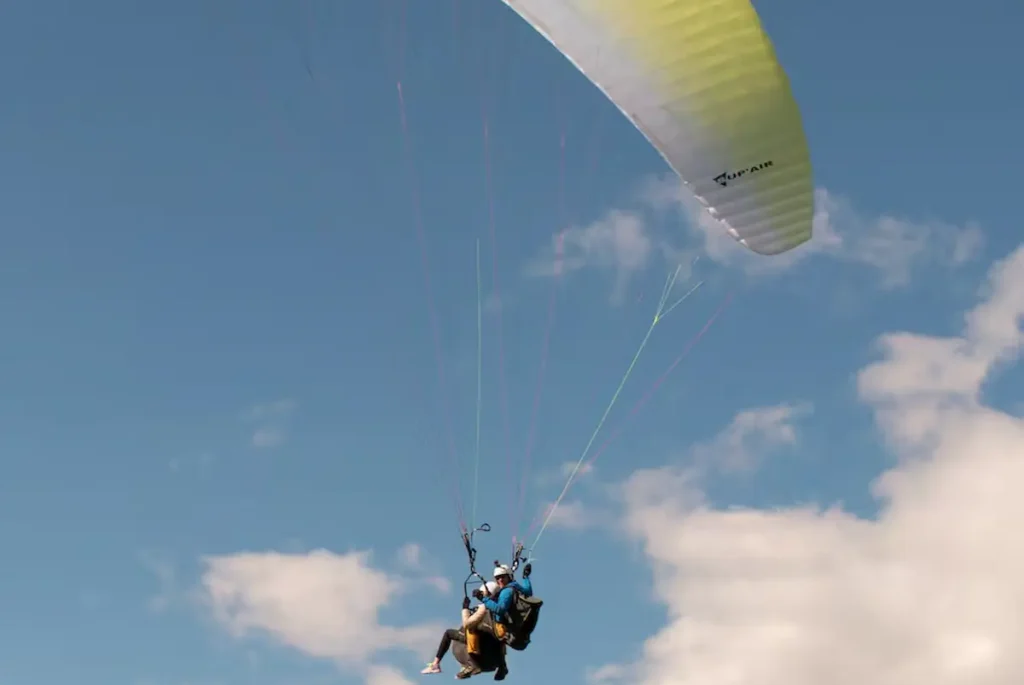 Tandem paragliding with a view of the glacier