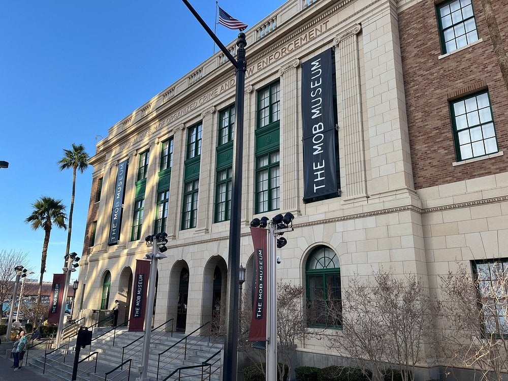 The Mob Museum building with large banners and green-trimmed windows in Las Vegas.
