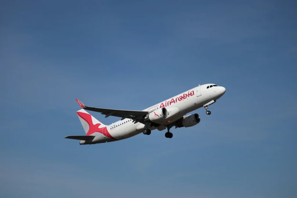 Air Arabia Airbus A320 commercial jetliner climbing in mid-air right after takeoff