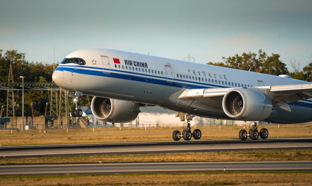 An Air China Airbus A350-900 widebody passenger airplane rotating and lifting off from an airport runway
