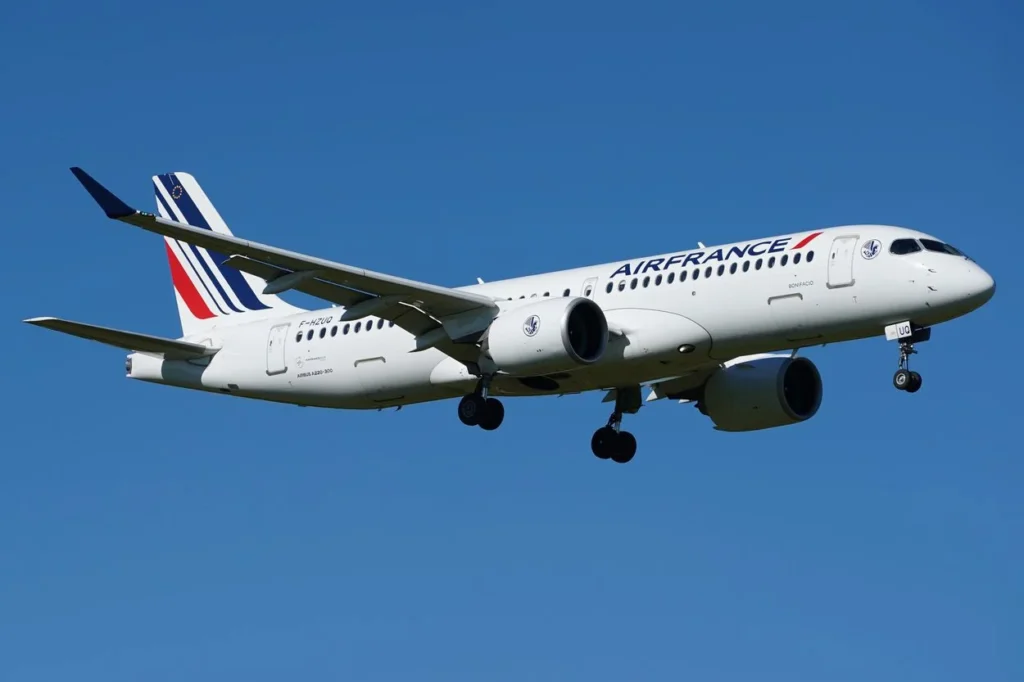 Air France Airbus A220 aircraft descending through a clear blue sky