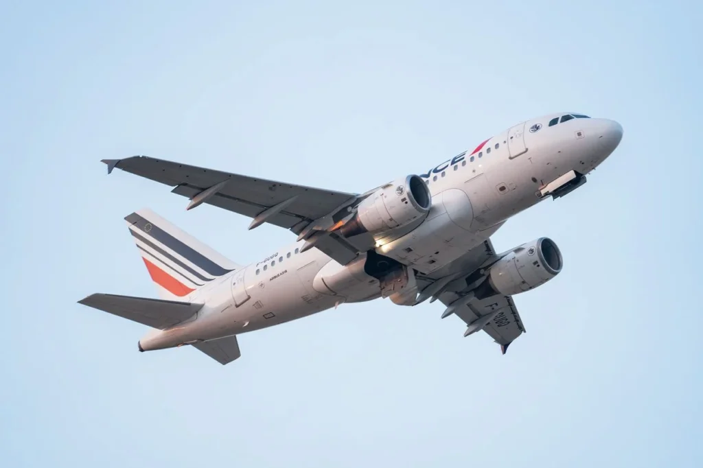 Air France Airbus A318 passenger airplane climbing steeply into the sky