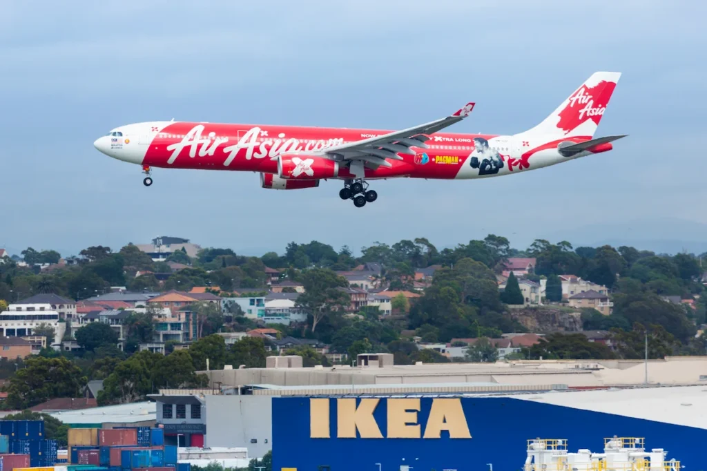AirAsia X Airbus A330 with Manny Pacquiao livery flying on landing approach over an IKEA store