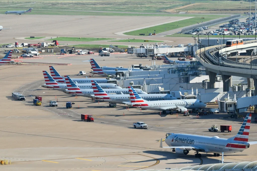 An aerial view of multiple American Airlines and American Eagle passenger regional jets