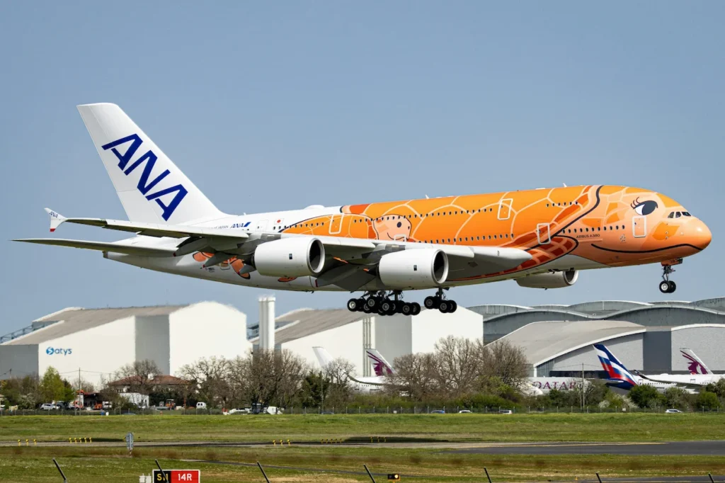 All Nippon Airways ANA Airbus A380 double-decker airplane in orange sea turtle