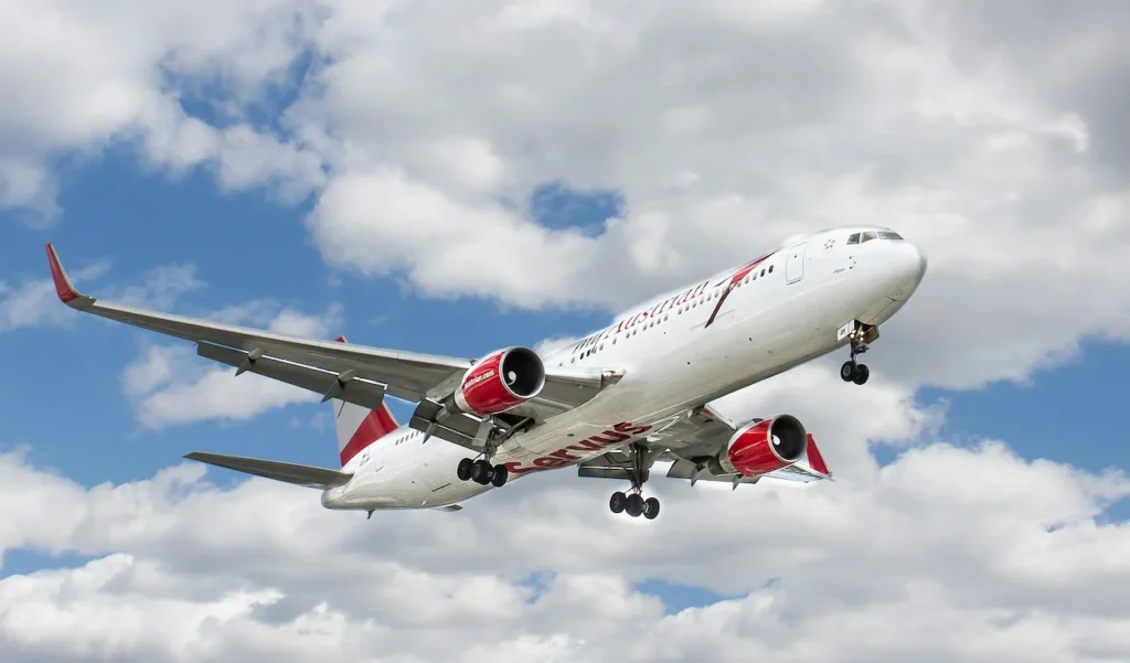 Austrian Airlines Boeing 767-300ER passenger airplane with registration OE-LAT descending through clouds