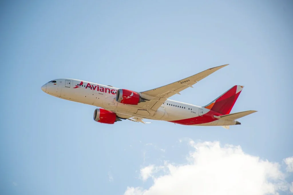 Avianca Boeing 787-8 Dreamliner passenger jet flying diagonally upward into a clear blue sky