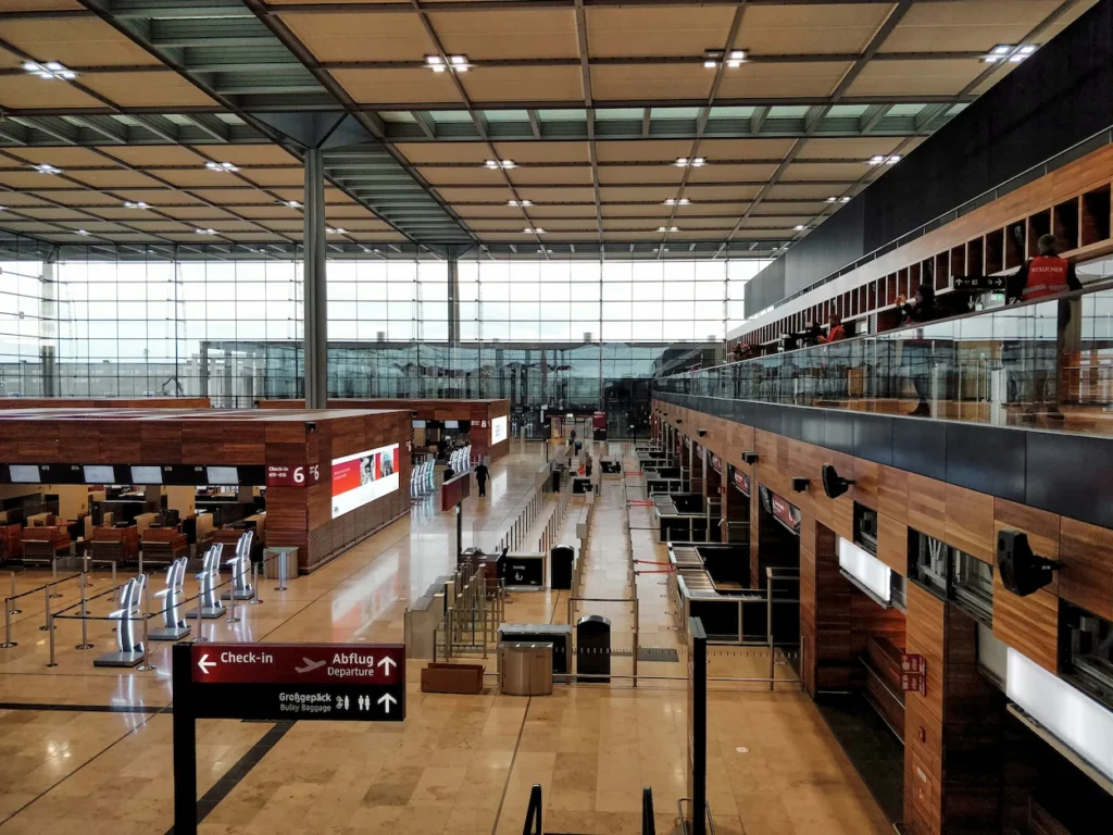 Elevated view of the spacious check-in counters and departure signage inside Berlin Brandenburg Airport