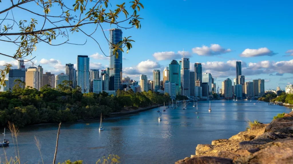 Brisbane city skyline and Brisbane River with sailboats docked along the city Botanic Gardens