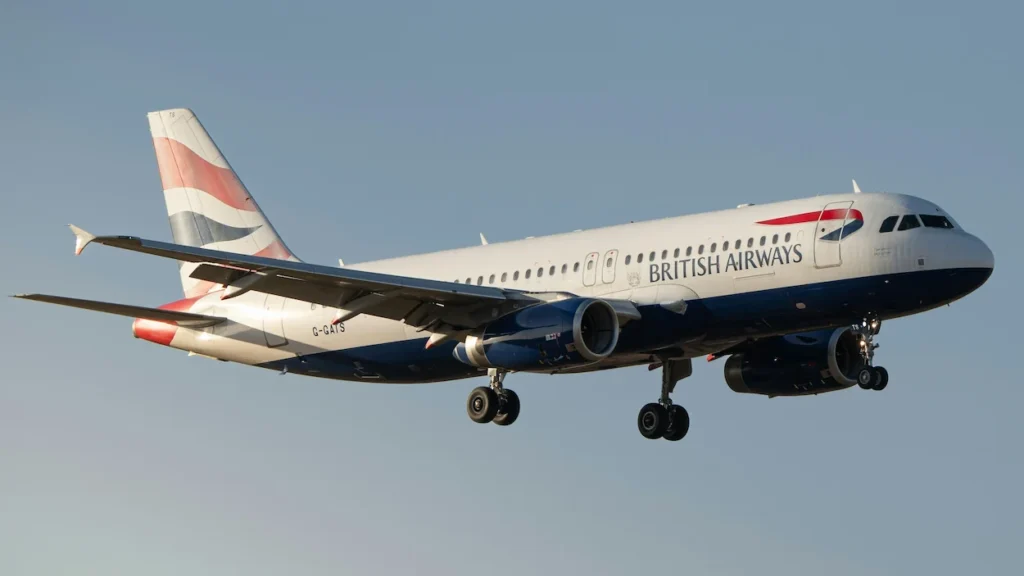 British Airways Airbus A320 passenger jet descending with its landing gear deployed