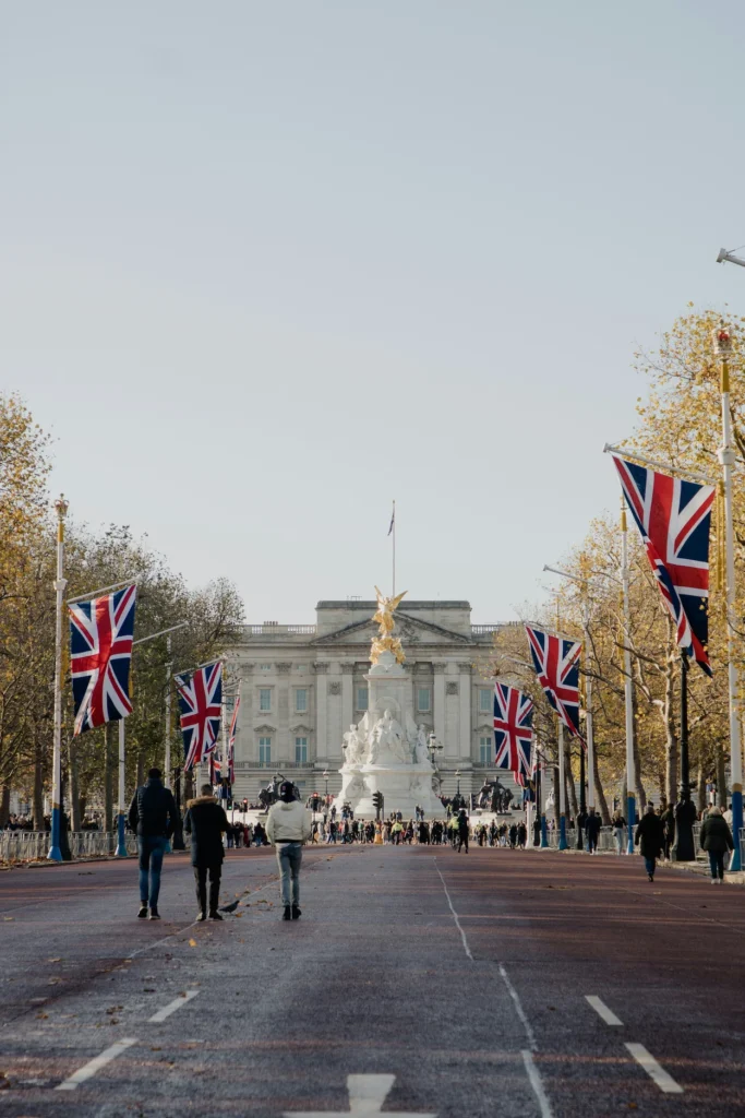 Buckingham Palace and the Victoria Memorial at the end of The Mall lined with Union Jack flags