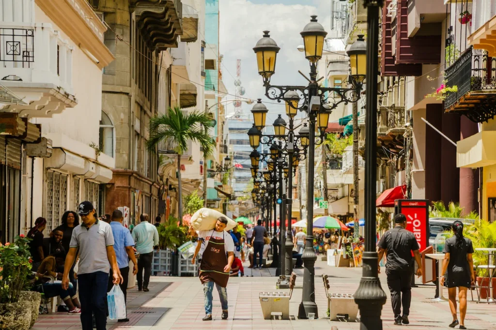 Pedestrian traffic walking along the historic shops and architecture of Calle El Conde in Santo Domingo