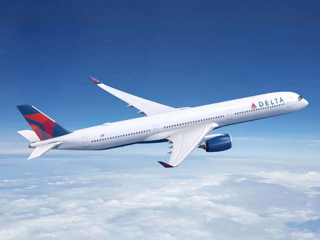 Delta Air Lines Airbus A350 widebody airplane soaring high in a bright blue sky