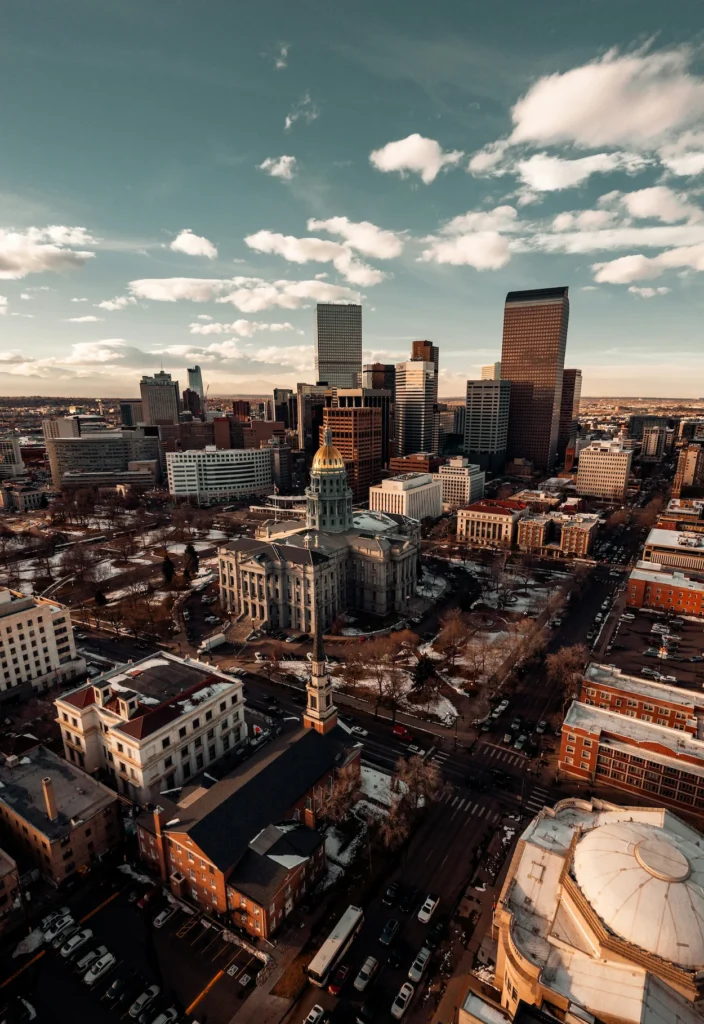 Golden dome of the Colorado State Capitol building against the downtown Denver skyline