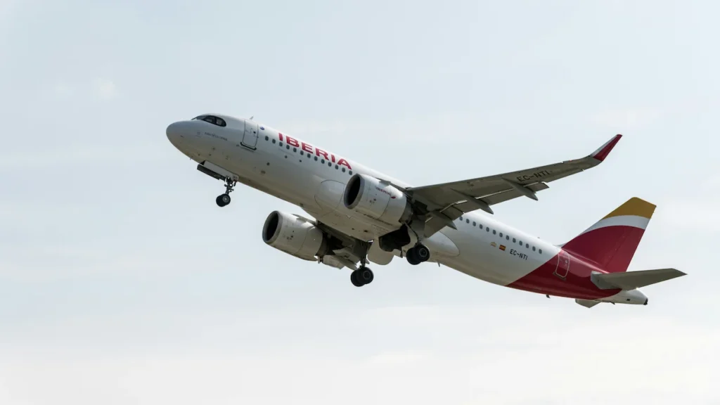An Iberia Airbus A320neo airplane ascending into the sky immediately after takeoff